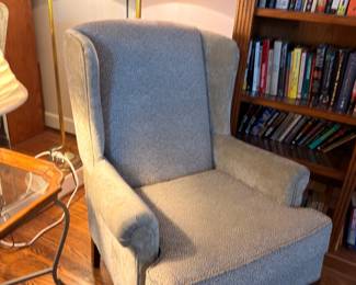 Gray upholstered wingback armchair