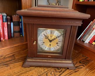 Vintage wooden mantel clock with brass face