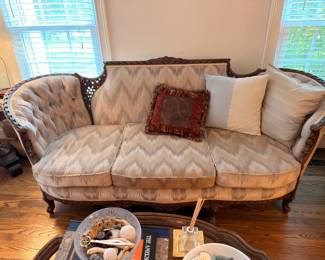Antique Victorian carved wood sofa with chevron upholstery