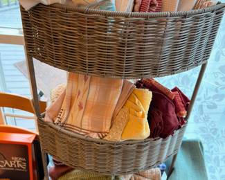 Three-tier wicker basket with linens and napkins