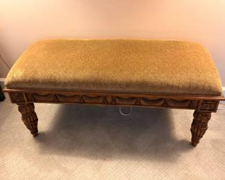 Vintage upholstered footstool with carved wood legs