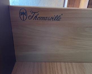 Wood branded with Thomasville maker's mark on interior drawer on armoire