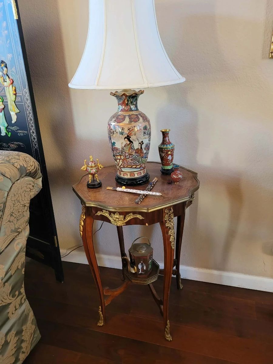 Louis XV style side table with bronze and marquetry work.  $200