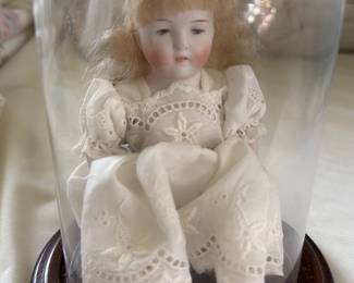 vintage antique doll in a glass dome