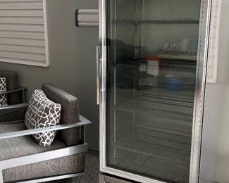 Another view of the TRUE refrigerator and the Prestige patio swivel armchair