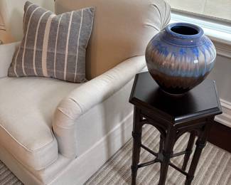 Cream linen armchair shown with hexagon side table and pottery vase - signed