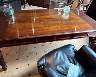 Executive Desk with 3-drawers and glass protective top, views include black leather office chair, paperweights, and glass marble jar
