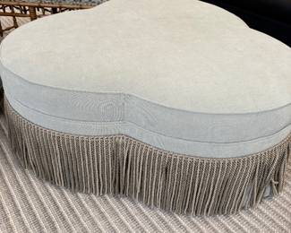 Large ottoman - upholstered with fringe and with casters - excellent condition