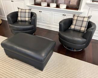 Italian leather "pebbled" leather ottoman with chrome feet, matched set of 2 black leather swivel barrel club chairs with chrome base and shown with wool plaid pillows with down inserts