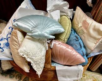 Large wicker basket filled with custom pillows