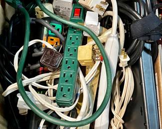 Box of extension cords, power strips, power adapters