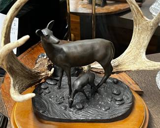 Bronze deer sculpture on wooden base