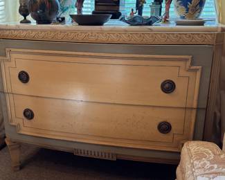Gustavian or Louis XVI style chest of drawers featuring a contrasting two-tone finish, decorative molding, and a marble top.
