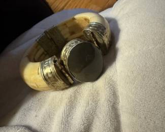 Vintage bone and silver-plated hinged bangle bracelet, typical of Indian handcrafted jewelry.