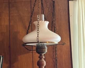 Vintage hanging swag lamp often referred to as a Gone with the Wind style lamp, featuring a milk glass shade with brass and wood accents.