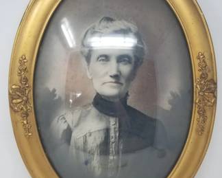 Victorian-era hand tinted photo print of Christina Halverson in an ornate convex bubble glass oval frame