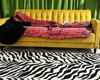 Zebra rug and yellow couch 