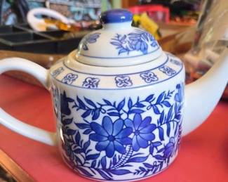 vintage porcelain teapot featuring a blue and white Asian-inspired floral pattern