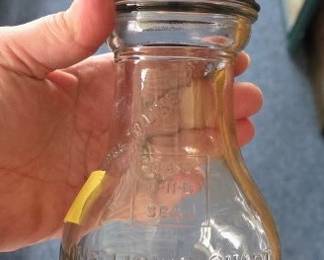 vintage antique glass oil bottle, typically used in gas stations during the 1920s to pour motor oil into vehicles