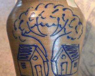 salt-glazed stoneware pottery featuring a blue cobalt hand-painted design of houses and a tree, likely made by Beaumont Brothers Pottery