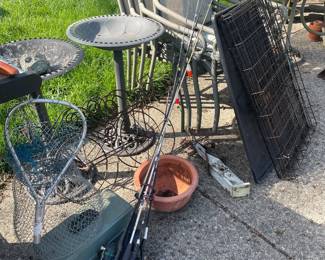 Dog cage, fishing poles, bird baths, flower pots