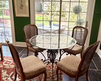 Stunning antique metal table with glass top - floral center is divine, cane chairs with leopard seatsta