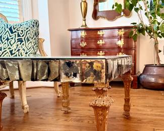Vintage Italian Venetian Mide Century Mirrored Coffee table featuring an antiqued mirrored glass and giltwood /carved legs