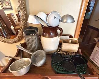 enamel ladles, cast iron advertising skillets, brown and cream pottery pitcher 