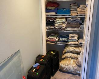 Linens, suitcases and glass