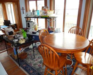 Table & chairs, kitchen items, sun room in back