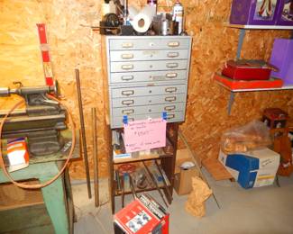 Cabinet filled with tools and equipment for lathe