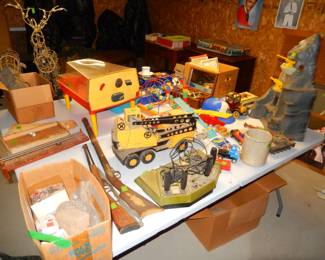 vintage toys, train set in far left box and plywood track against wall