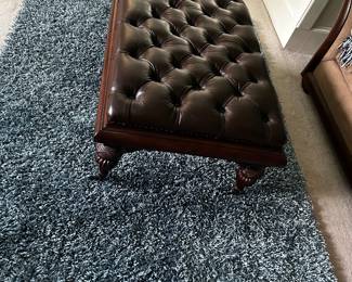 Tufted ottoman and area rug
