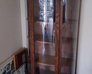 vintage quarter sawn oak curio cabinet, likely dating from the early 1900s, featuring curved glass panels.