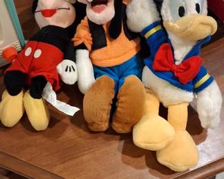 vintage Disney plush bean bag toys, specifically including Mickey Mouse, Goofy, and Donald Duck. 