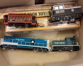 vintage HO scale model train locomotives and a trolley car. 