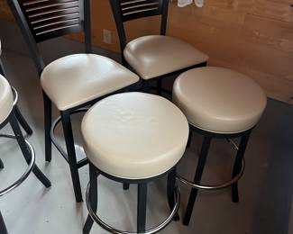 Five high top tables, 10 bar stools, and six bar chairs/stools by MTS Seating (chairs) and Custer (tables).