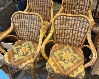 Four wicker chairs with cushions.