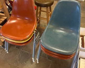 Six Herman Miller Eames shell chairs.
