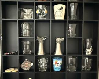 Assorted Shot Glasses and Collectibles Display with Jack Daniel's Barrel Jar