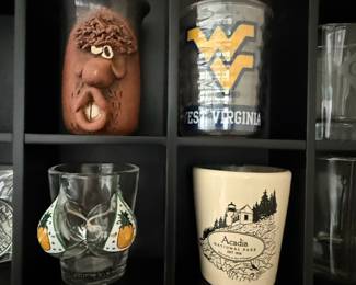 Assorted Shot Glasses and Collectibles Display with Jack Daniel's Barrel Jar