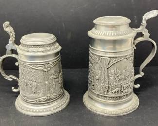 Pair of German Pewter Beer Steins with Embossed Relief Scenes