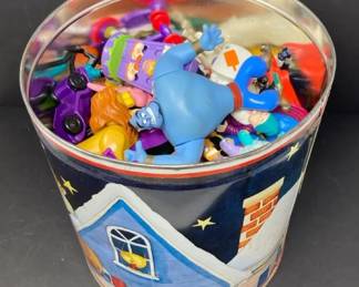 Assorted Toy Figurines in Decorative Metal Tin