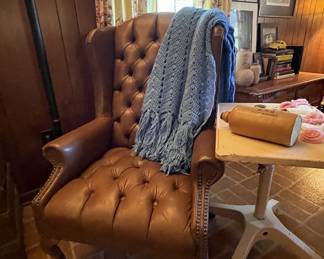 Leather wing back chair, medical table