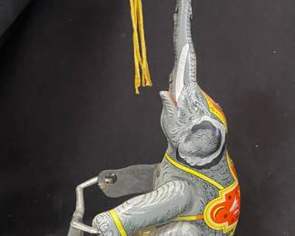 a Schylling Tin Elephant on a Bike wind-up collectible