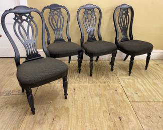 black dining chairs feature a shield-back design inspired by the English Chippendale style, paired with upholstered seats and twisted legs