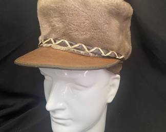 a vintage faux fur and leather military-style cadet cap featuring a pom-pom on top