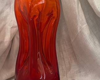 a vintage ruby red "Kluk Kluk" (or "Glug Glug") decanter.  Origin: Produced by Danish glassworks Kastrup Holmegaard, designed by Jacob E. Bang in the mid-20th century