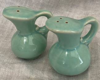 vintage ceramic salt and pepper shakers styled as miniature pitchers in a turquoise or sea green glaze