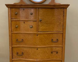 an antique bird's-eye maple chest of drawers featuring a serpentine front, a detachable beveled oval mirror, and a small compartmented cabinet, early 1900s, top veneer needs to be replaced